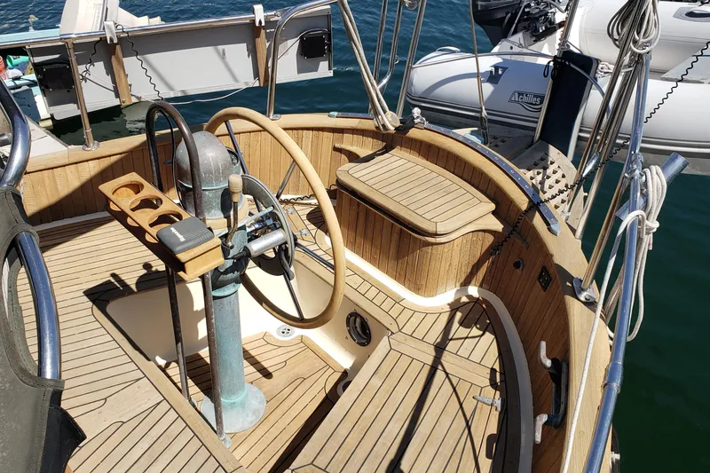 Slide: The Image of Cockpit of a 1987 Hans Christian 33 sailboat with wooden steering wheel and deck. - 14