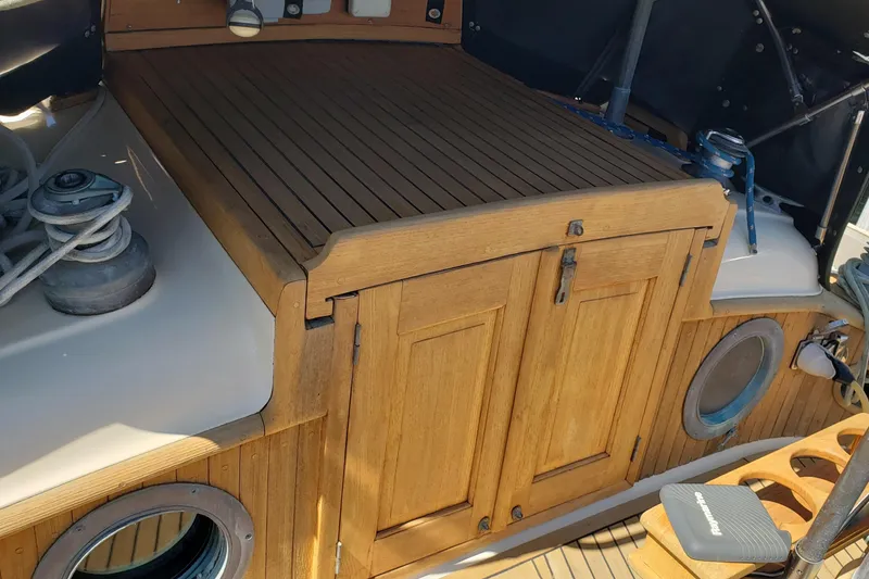 Slide: The Image of 1987 Hans Christian 33 sailboat cockpit with wooden hatch and nautical equipment. - 15