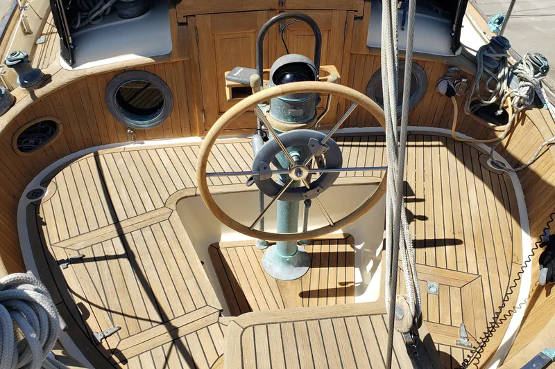 Slide: The Image of Cockpit of 1987 Hans Christian 33 sailboat with wooden steering wheel and deck. - 16