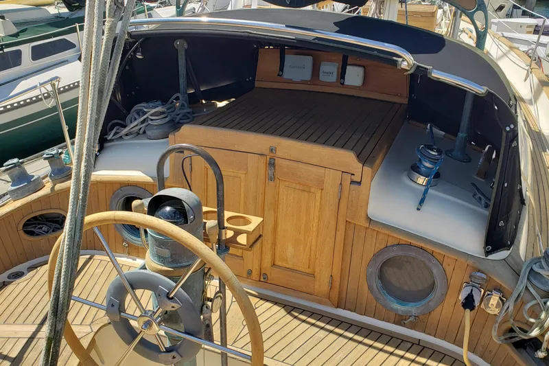Slide: The Image of 1987 Hans Christian 33 sailboat cockpit with wooden helm and nautical equipment. - 17