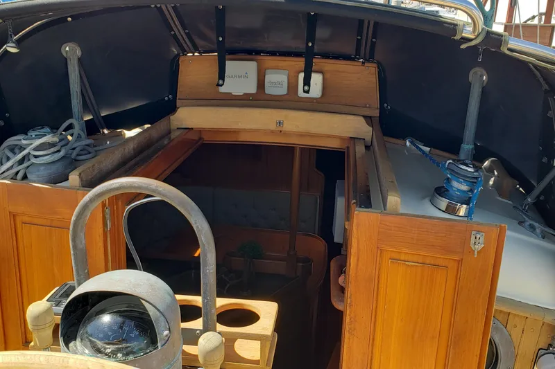 Slide: The Image of Cockpit view of 1987 Hans Christian 33 sailboat with wooden interior and navigation equipment. - 19