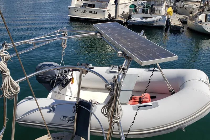 Slide: The Image of Inflatable boat with solar panel on a 1987 Hans Christian 33 yacht in marina. - 24