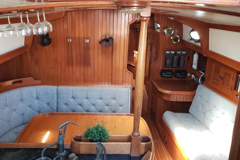 Slide: The Image of Interior of a 1987 Hans Christian 33 sailboat with wood paneling and cozy seating. - 26