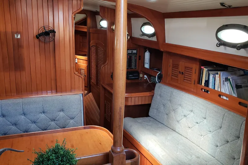 Slide: The Image of Interior of 1987 Hans Christian 33 sailboat with wooden paneling and cushioned seating. - 27