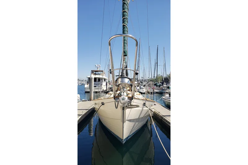 Slide: The Image of 1987 Hans Christian 33 sailboat docked at marina, clear blue sky background. - 3