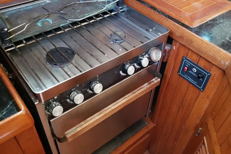 Slide: The Image of Stainless steel stove in 1987 Hans Christian 33 yacht kitchen, surrounded by wooden cabinetry. - 31
