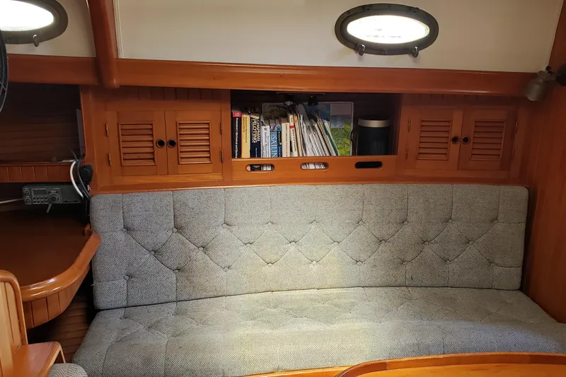 Slide: The Image of Interior of 1987 Hans Christian 33 sailboat with cushioned seating and wooden cabinetry. - 37