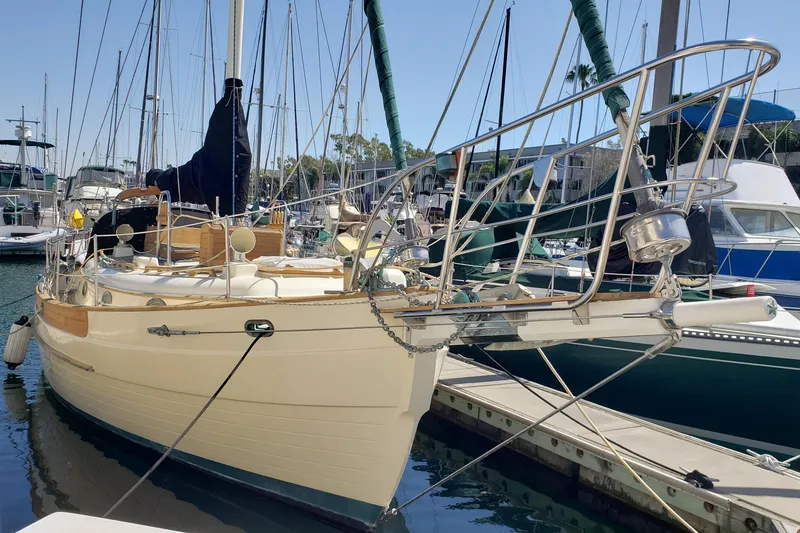 Slide: The Image of 1987 Hans Christian 33 sailboat docked in a marina, showcasing classic design. - 4