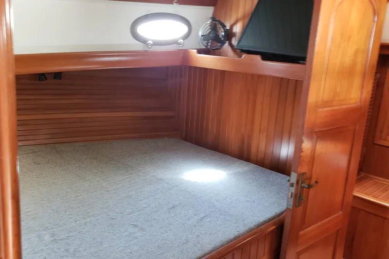 Slide: The Image of Cozy cabin interior of 1987 Hans Christian 33 sailboat with wooden paneling and bed. - 40