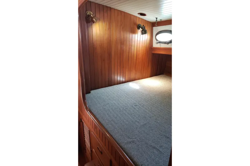 Slide: The Image of Cozy wooden cabin interior of 1987 Hans Christian 33 sailboat with bed and porthole. - 41