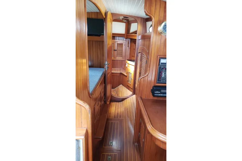 Slide: The Image of Interior of 1987 Hans Christian 33 sailboat with wooden paneling and cozy cabin layout. - 42