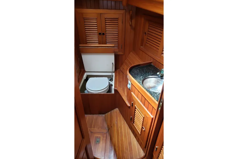 Slide: The Image of 1987 Hans Christian 33 yacht bathroom with wooden cabinetry and compact sink. - 44
