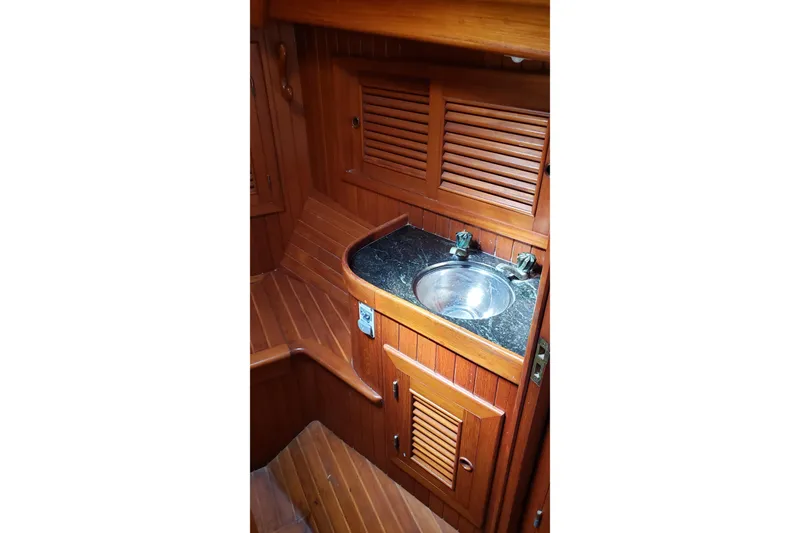 Slide: The Image of 1987 Hans Christian 33 yacht interior with wooden cabinetry and stainless steel sink. - 45
