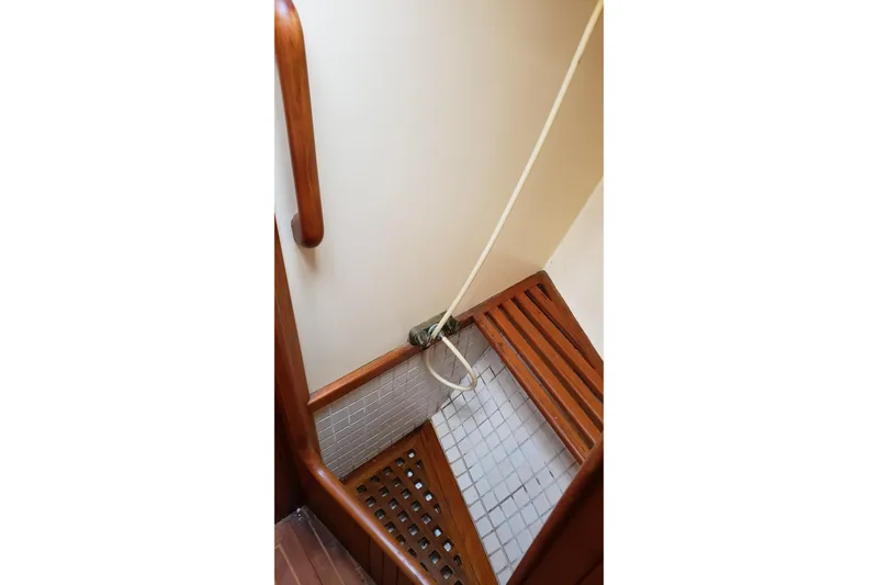 Slide: The Image of Shower area in 1987 Hans Christian 33 sailboat with wooden bench and tiled floor. - 46