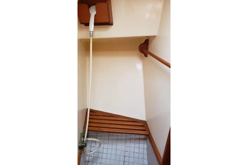 Slide: The Image of Shower area in 1987 Hans Christian 33 yacht with wooden accents and handheld showerhead. - 47