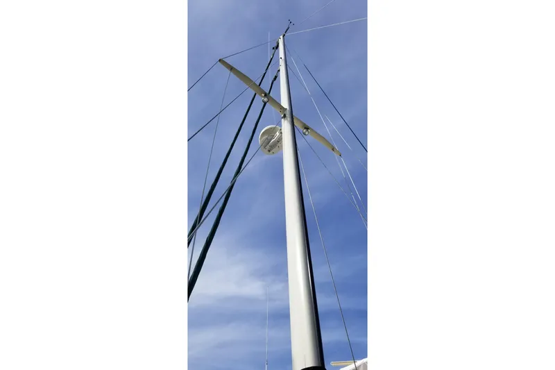 Slide: The Image of Mast of 1987 Hans Christian 33 sailboat against a clear blue sky. - 49