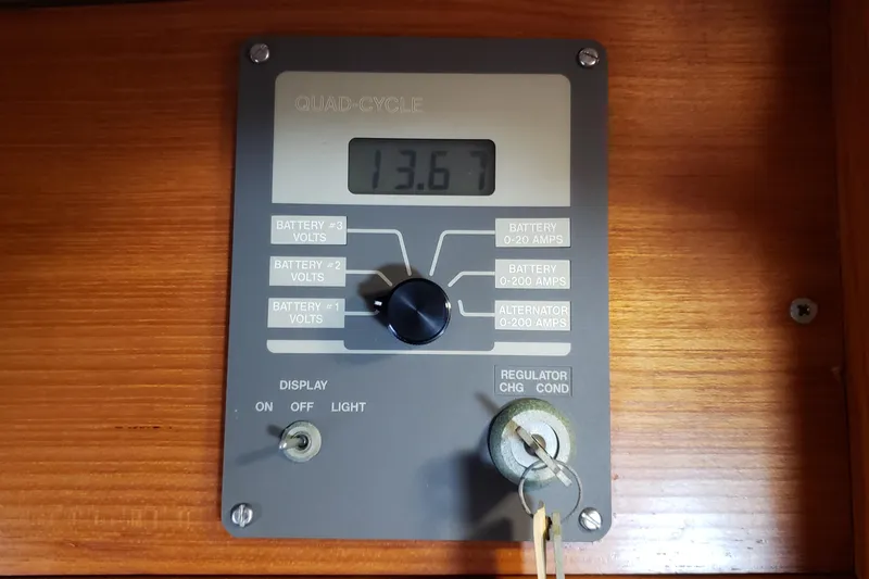Slide: The Image of Battery monitor panel on 1987 Hans Christian 33 sailboat, displaying voltage reading of 13.67. - 54