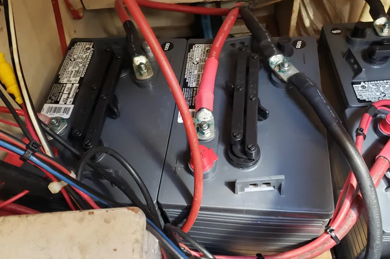 Slide: The Image of Battery setup with red and black cables in a 1987 Hans Christian 33 boat. - 56