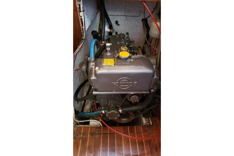Slide: The Image of Engine compartment of a 1987 Hans Christian 33 sailboat, featuring a marine diesel engine. - 59