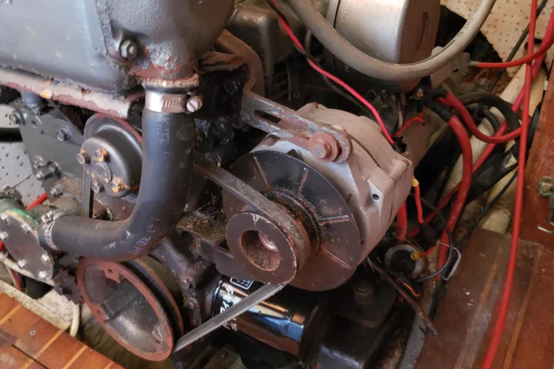 Slide: The Image of Engine compartment of a 1987 Hans Christian 33 sailboat, showing mechanical components and wiring. - 61