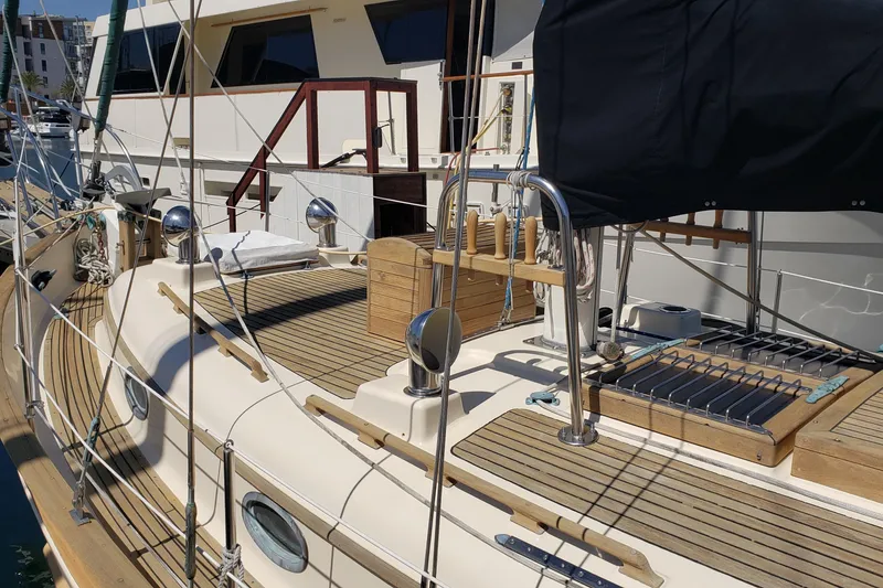 Slide: The Image of 1987 Hans Christian 33 sailboat deck with wooden accents and nautical equipment. - 9