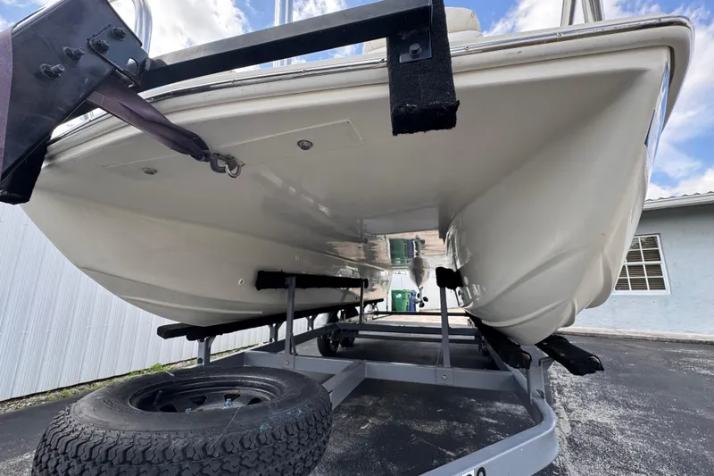 Slide: The Image of Underside view of a 2018 Beachcat 20 boat on a trailer, showcasing hull design. - 11