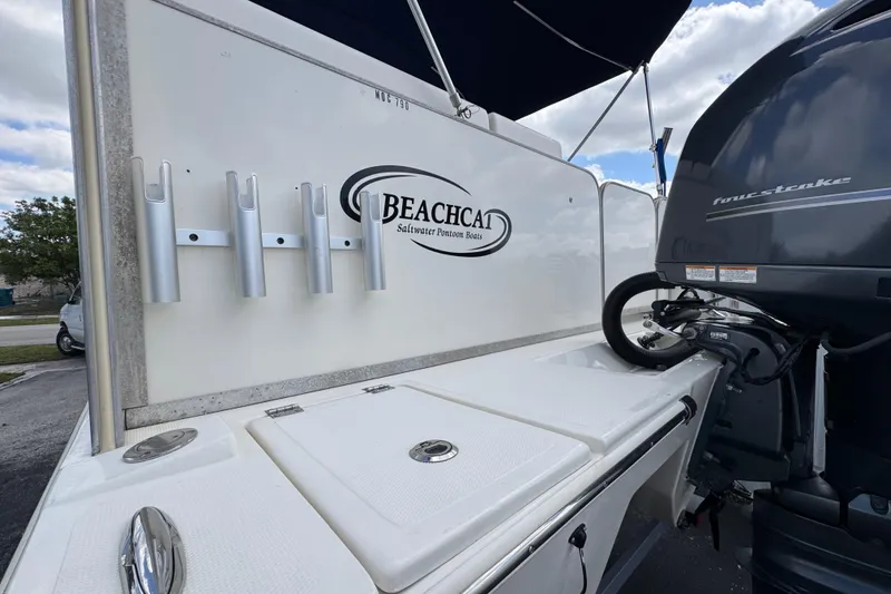 Slide: The Image of 2018 Beachcat 20 boat with rod holders and outboard motor, ideal for saltwater fishing. - 14