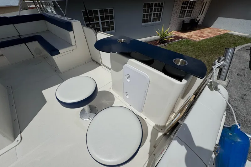 Slide: The Image of 2018 Beachcat 20 boat interior with seating, table, and cup holders. - 23