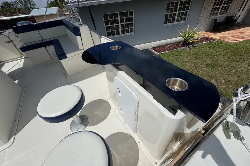 Slide: The Image of 2018 Beachcat 20 boat interior with seating, bar area, and cup holders. - 24