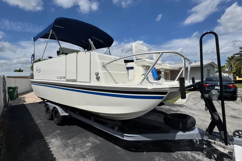 Slide: The Image of 2018 Beachcat 20 boat on trailer, parked outdoors under a blue sky. - 3
