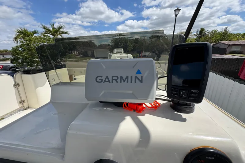 Slide: The Image of Garmin navigation system on 2018 Beachcat 20 boat, under a partly cloudy sky. - 36