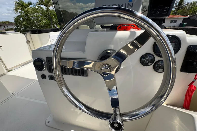 Slide: The Image of Steering wheel of a 2018 Beachcat 20 boat with navigation instruments. - 37