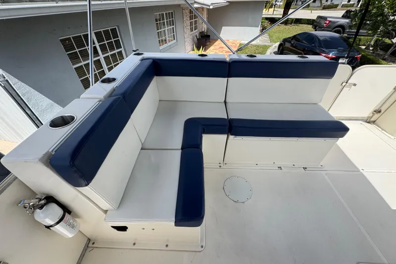 Slide: The Image of 2018 Beachcat 20 boat interior with blue and white seating, cup holders, and fire extinguisher. - 40