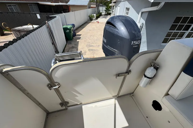 Slide: The Image of 2018 Beachcat 20 boat with Yamaha 150 engine, docked in a residential driveway. - 41