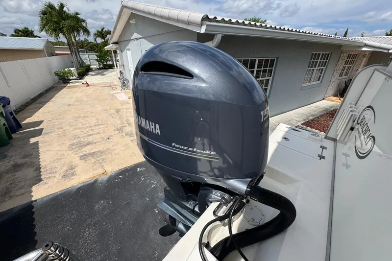 Slide: The Image of Yamaha outboard motor on a 2018 Beachcat 20 boat, parked near a house. - 43