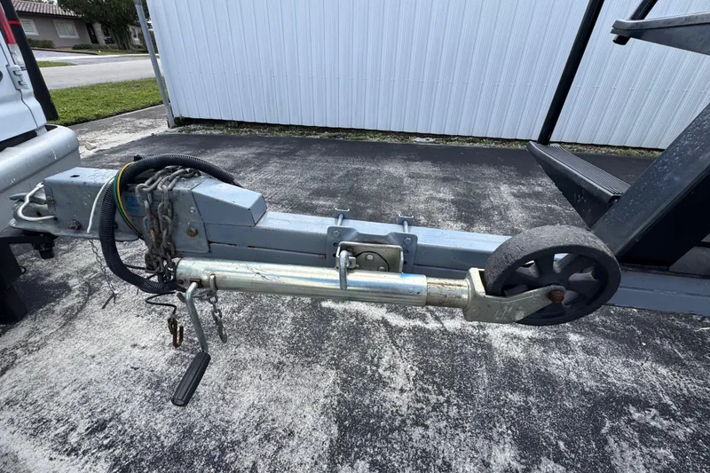 Slide: The Image of Trailer hitch and wheel of a 2018 Beachcat 20 boat on pavement. - 50