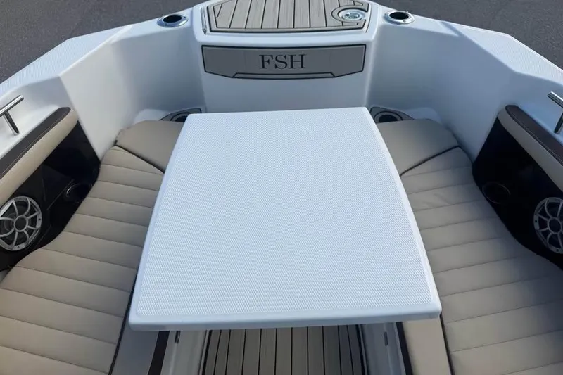 Slide: The Image of 2023 Yamaha Boats 255 FSH Sport E interior with seating and table. - 14