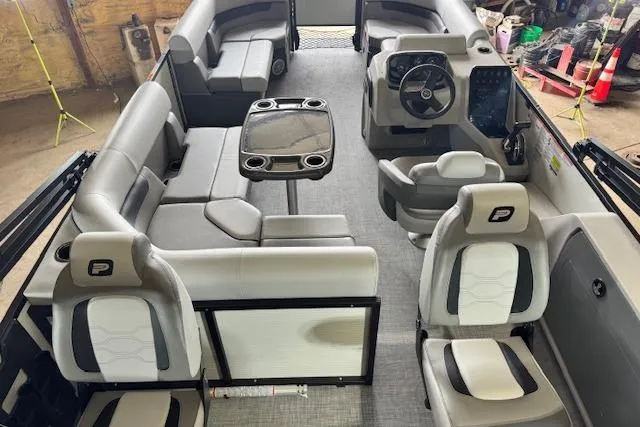 Slide: The Image of 2026 Princecraft Sportfisher 21-2RS pontoon boat interior with seating and steering console. - 10