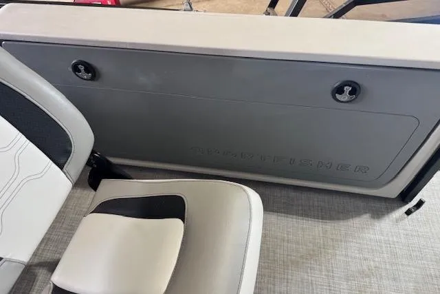 Slide: The Image of 2026 Princecraft Sportfisher 21-2RS boat interior with seating and storage compartment. - 19