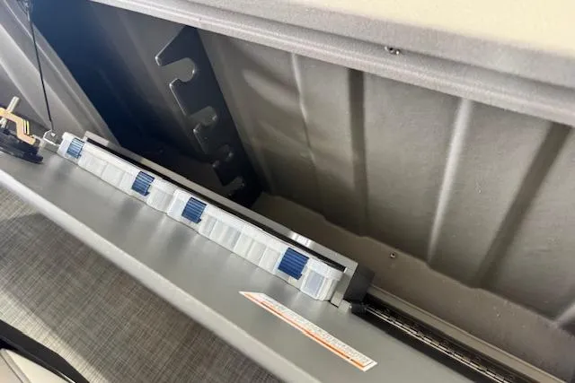 Slide: The Image of 2026 Princecraft Sportfisher 21-2RS boat interior storage compartment with organized rod holders. - 23