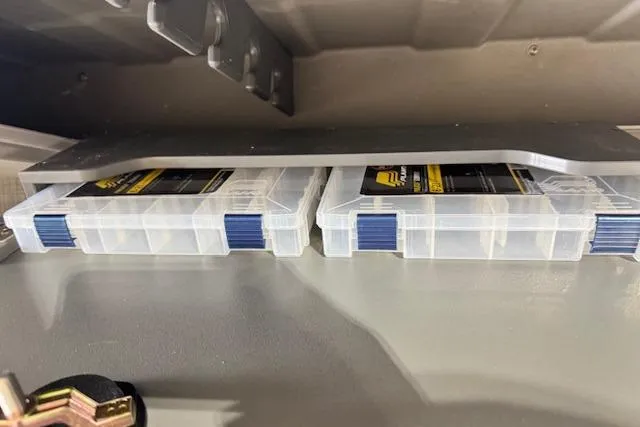 Slide: The Image of Storage compartments with clear plastic boxes in a 2026 Princecraft Sportfisher 21-2RS boat. - 25