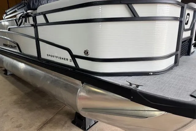 Slide: The Image of 2026 Princecraft Sportfisher 21-2RS pontoon boat, side view in a showroom. - 4