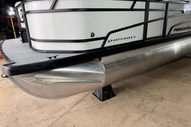 Slide: The Image of 2026 Princecraft Sportfisher 21-2RS pontoon boat, side view, on display indoors. - 5