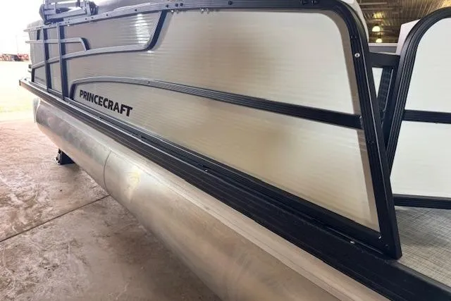 Slide: The Image of 2026 Princecraft Sportfisher 21-2RS pontoon boat, side view in a storage area. - 7
