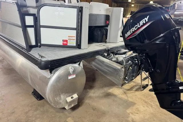 Slide: The Image of 2026 Princecraft Sportfisher 21-2RS pontoon boat with Mercury outboard motor in a garage. - 8