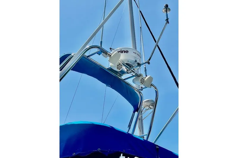 Slide: The Image of Radar and antennas on a 1988 Mediterranean 38 Convertible boat against a clear blue sky. - 11