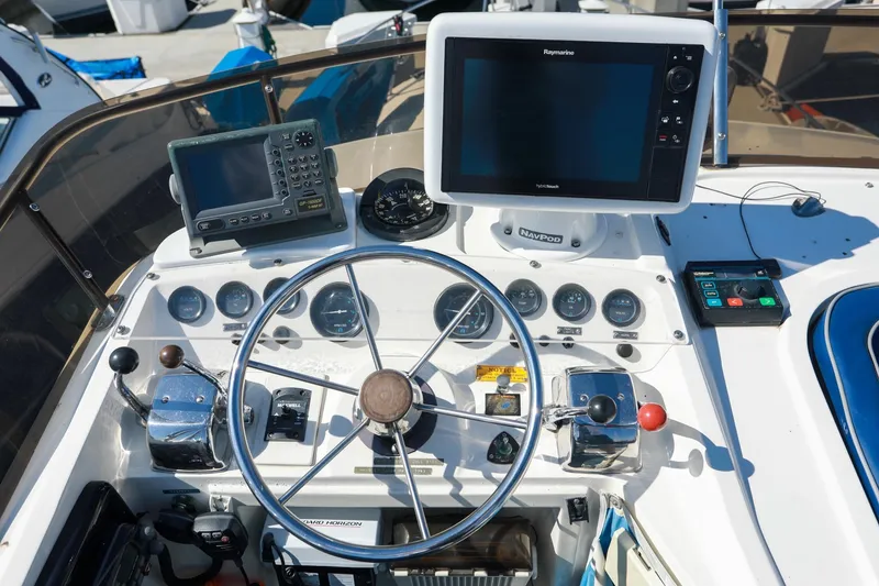 Slide: The Image of Cockpit of a 1988 Mediterranean 38 Convertible boat with navigation equipment and steering wheel. - 12
