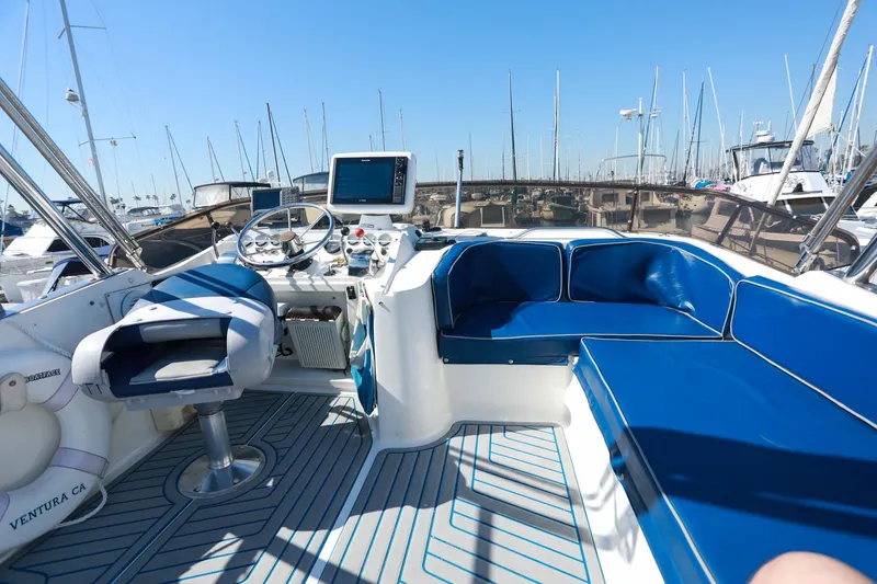 Slide: The Image of Cockpit of 1988 Mediterranean 38 Convertible yacht with blue seating and steering controls. - 13