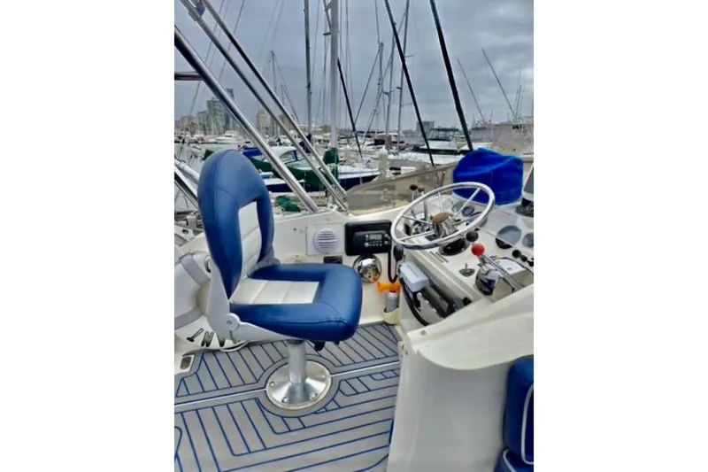 Slide: The Image of Cockpit of 1988 Mediterranean 38 Convertible yacht with blue seating and steering wheel. - 18