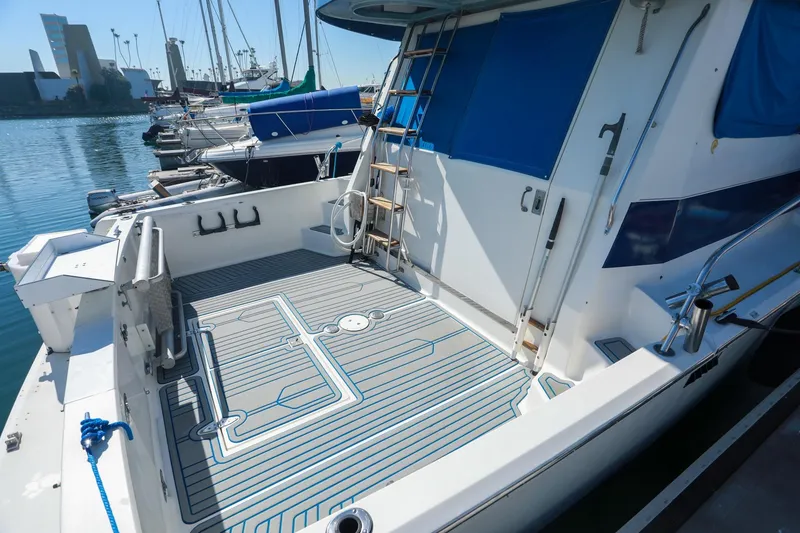 Slide: The Image of 1988 Mediterranean 38 Convertible yacht with spacious deck, docked in a marina. - 19